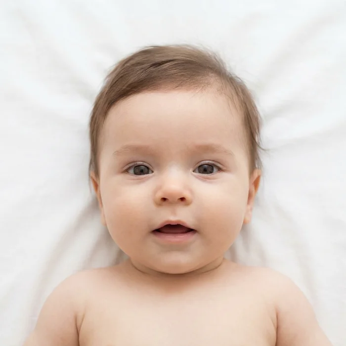Acceptable baby passport photo example — acceptable — the white sheet method